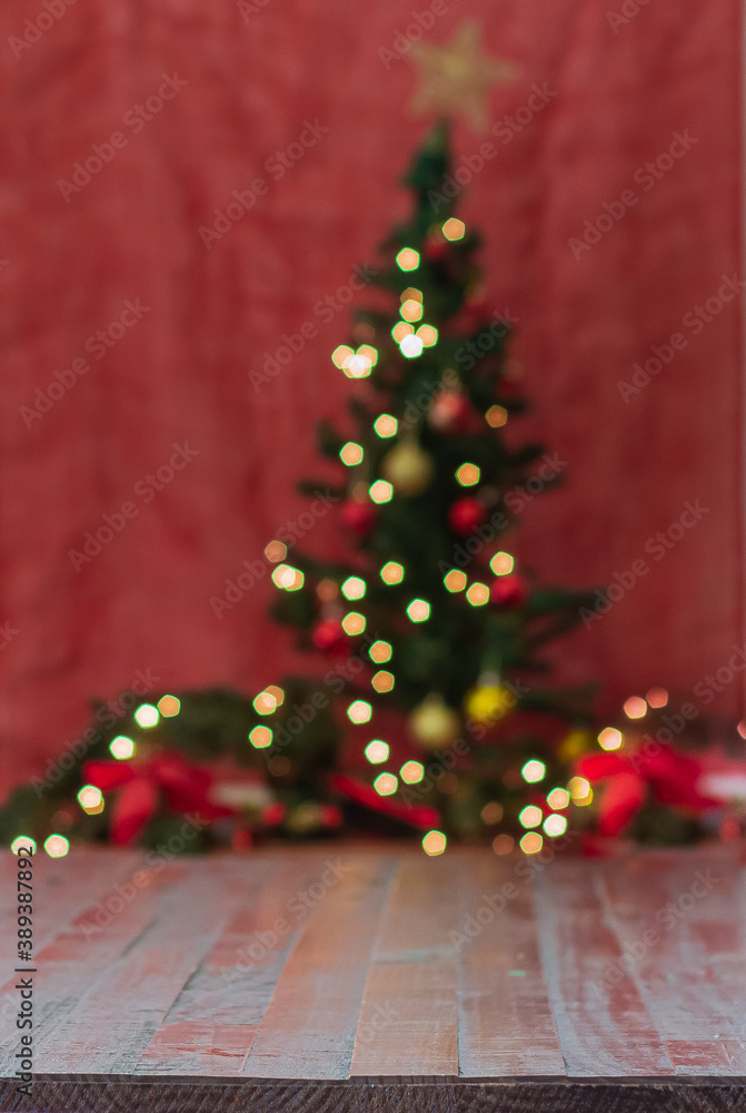 wooden table with defocused chistmas tree on background