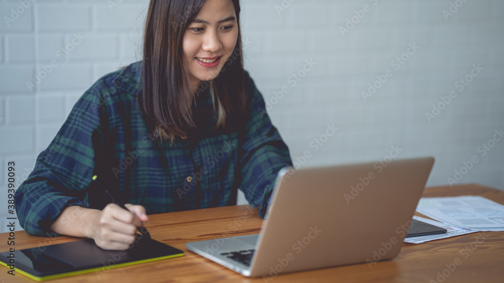 Asian women working at home using a lab. Graphic design. Working with pleasure. Concept work at home. Asian women working at home using a lab. Graphic design. Working with pleasure. Concept work at home.