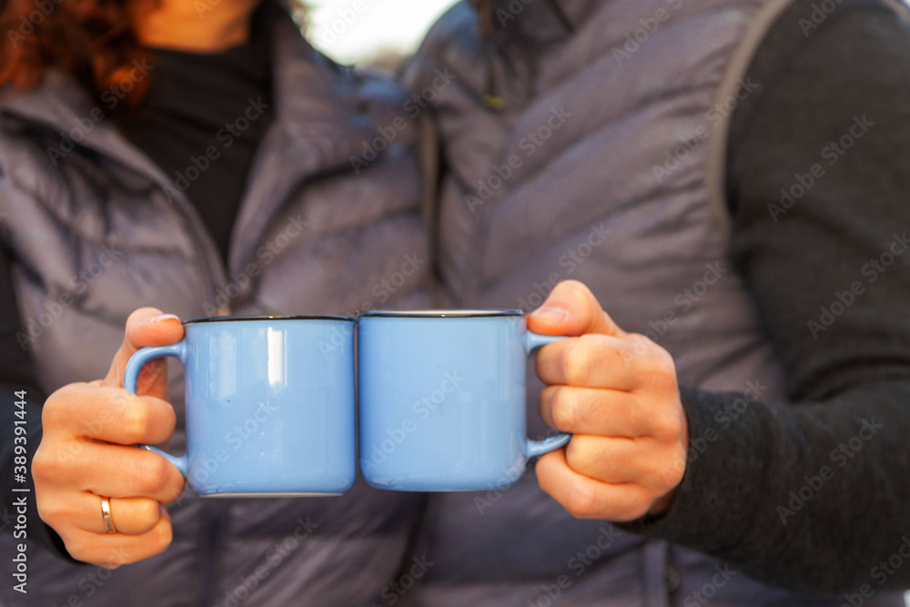 blue cups in the hands of a couple in love close-up, selective focus blue cups in the hands of a couple in love close-up, selective focus