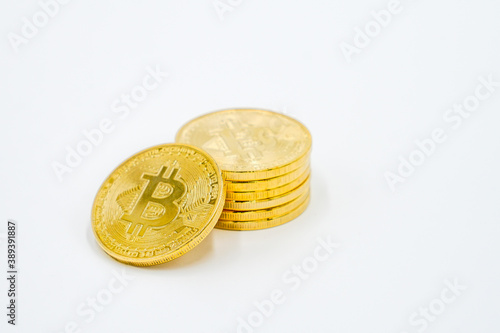 Close Up Shot of Golden Bitcoins on a white Background: Future Currency - fincance concept - free white space photo