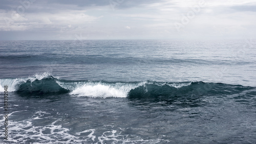 Small waves crashing on the sea, seascape horizon, peaceful and mighty nature, water element, freedom travel concept