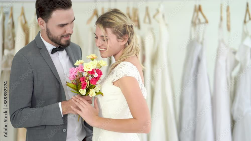 Married couple, groom giving the bride a bouquet, smiling happily.
Married couple, groom giving the bride a bouquet, smiling happily.