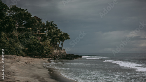 Dramatic beach with black sand before the storm, cloudy and dark weather