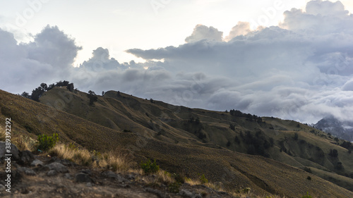 landscape with clouds, panorama of the mountains in the morning, sunrise over the hills and mountains with fluffy clouds, Lombok Island, Indonesia