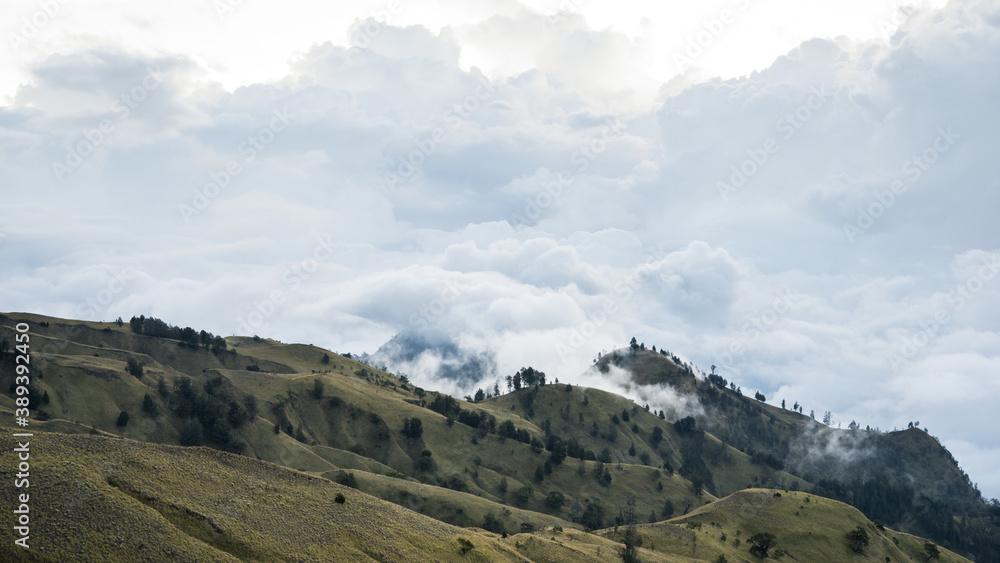 landscape with clouds, panorama of the mountains in the morning, sunrise over the hills and mountains with fluffy clouds, Lombok Island, Indonesia landscape with clouds, panorama of the mountains in the morning, sunrise over the hills and mountains with fluffy clouds, Lombok Island, Indonesia
