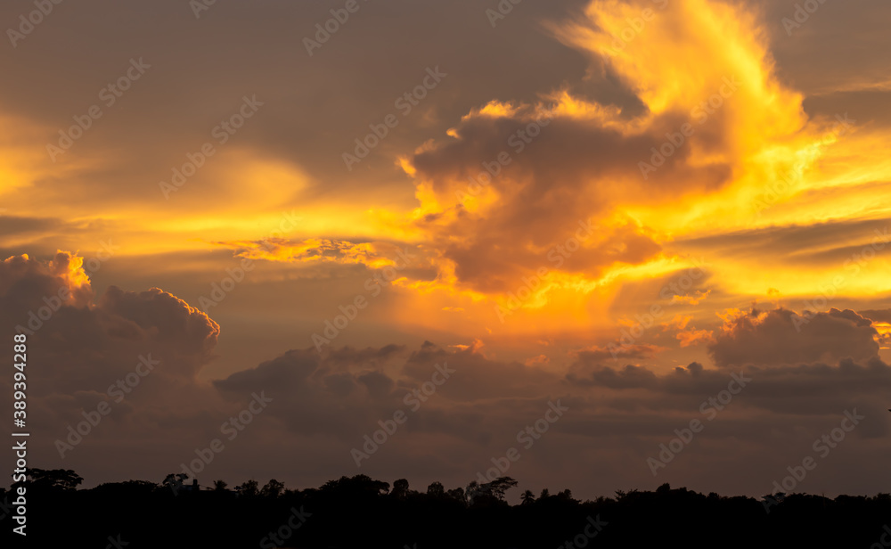 Gorgeous dramatic strong sunset yellow and dark blue evening sky