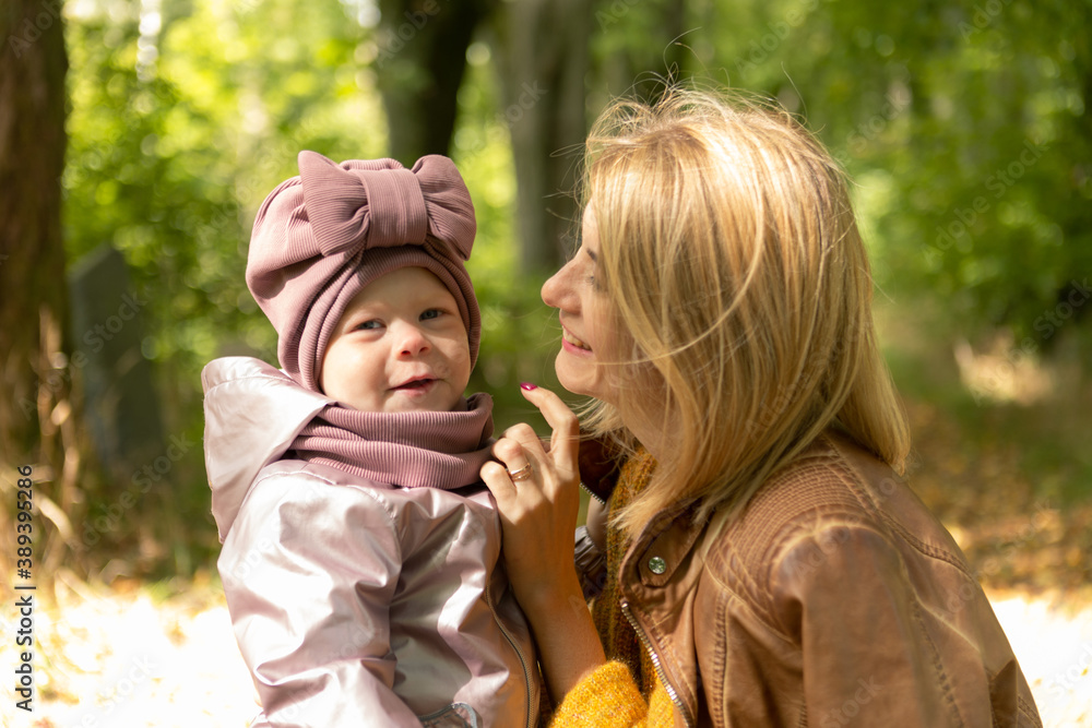 Beauty woman with cute little daughter walking in the autumn forest Beauty woman with cute little daughter walking in the autumn forest