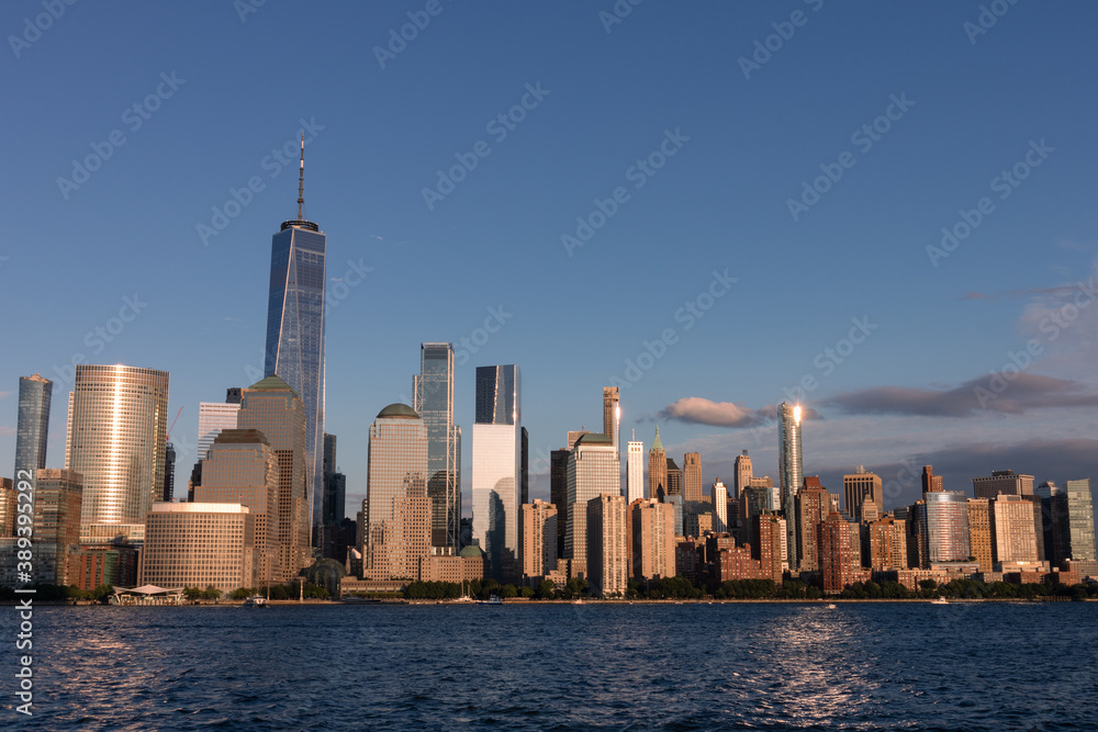 Lower Manhattan Skyline along the Hudson River in New York City Shining during a Sunset
