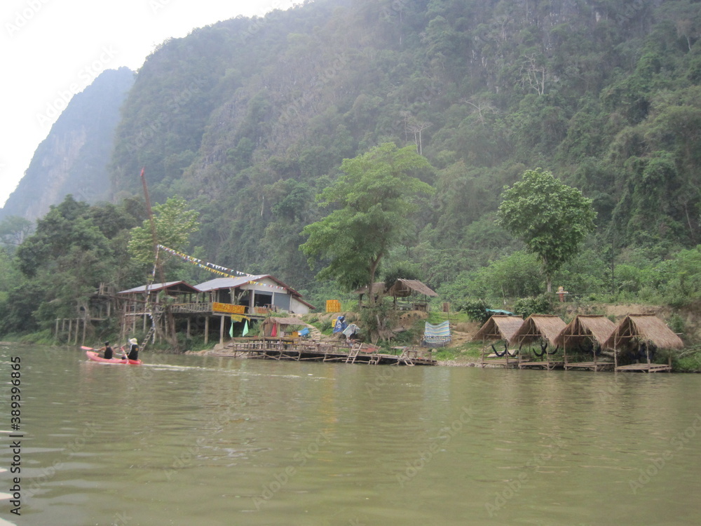 Obraz premium Traveling down the Mekong River and through the jungle landscapes of Laos in Southeast Asia