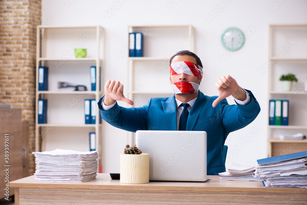 Mouth and eyes closed male employee working in the office Mouth and eyes closed male employee working in the office