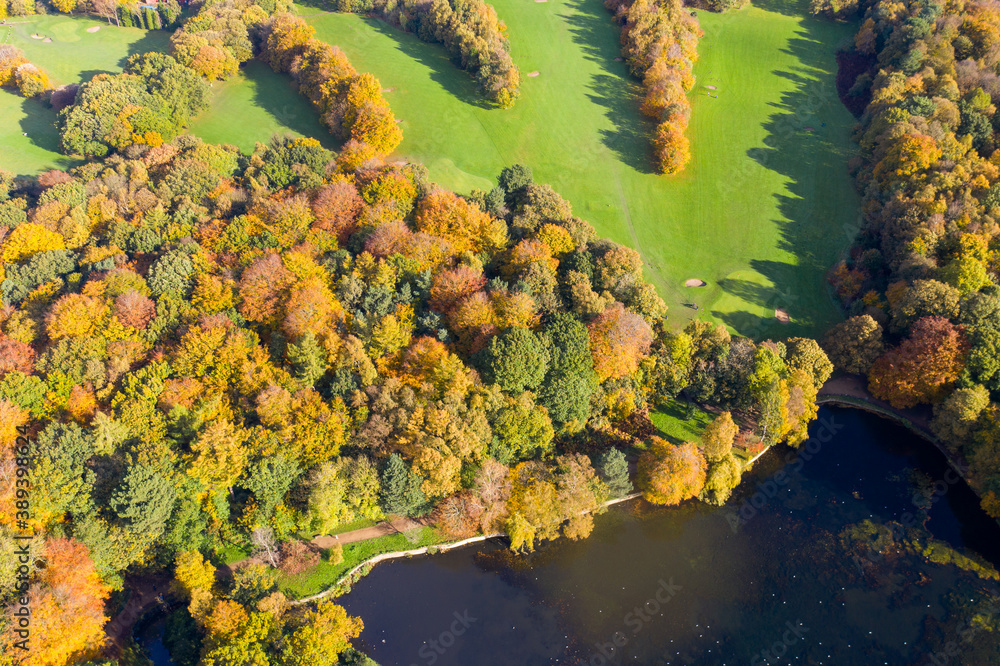 A beautiful aerial photo in the autumn fall at the park in Leeds West Yorkshire known as Roundhay Park showing the brown and green colours on the trees A beautiful aerial photo in the autumn fall at the park in Leeds West Yorkshire known as Roundhay Park showing the brown and green colours on the trees