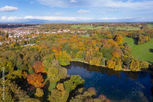 A beautiful aerial photo in the autumn fall at the park in Leeds West Yorkshire known as Roundhay Park showing the brown and green colours on the trees