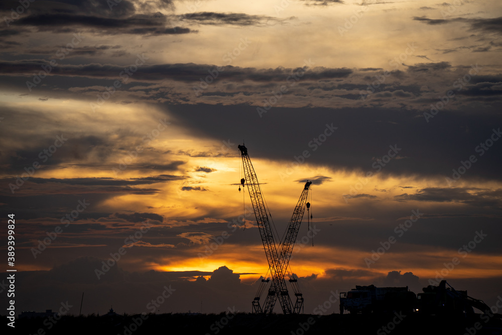 Crane Stood Still at the construction site at sunset