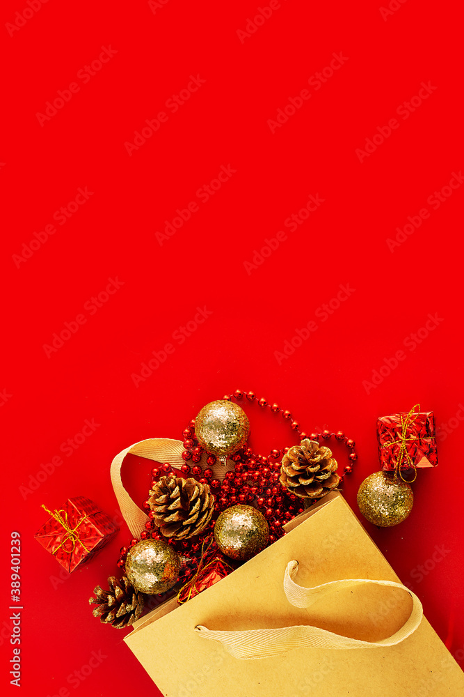 Christmas decorations in a bag on a red background. Place for your text.