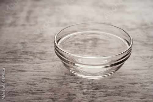 Empty glass bowl on a white wooden background
