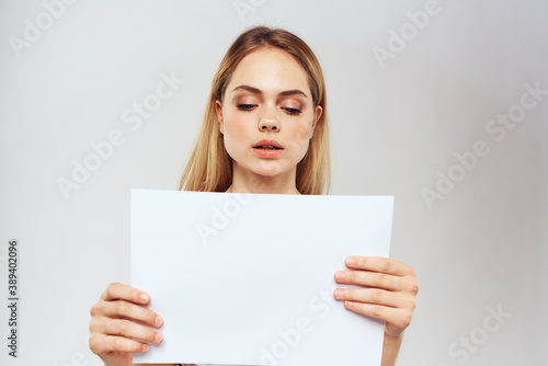 woman holding a sheet of paper in her hands lifestyle striped t-shirt cropped view Copy Space