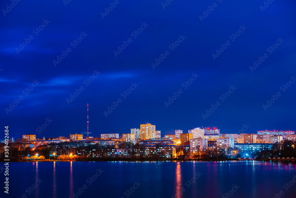 A night panorama of city with illuminated buildings. Izhevsk pond. 