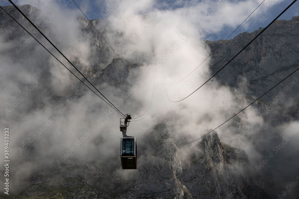 Fototapeta premium Cable car in front of a foggy mountain
