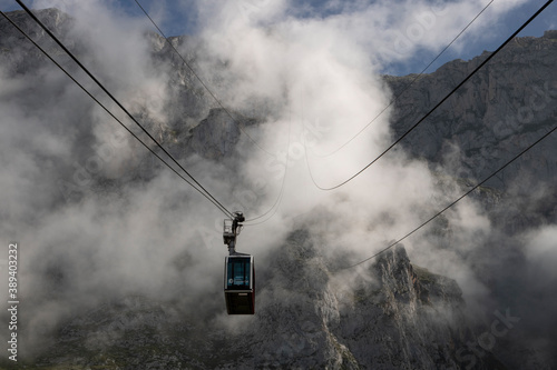 Cable car in front of a foggy mountain photo