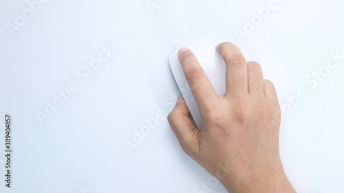 top view of women hand using computer mouse on white background  photo