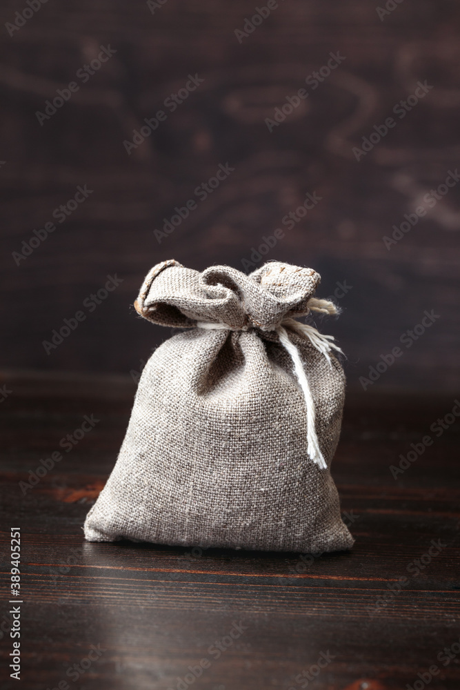 Small filled pouch on old wooden table