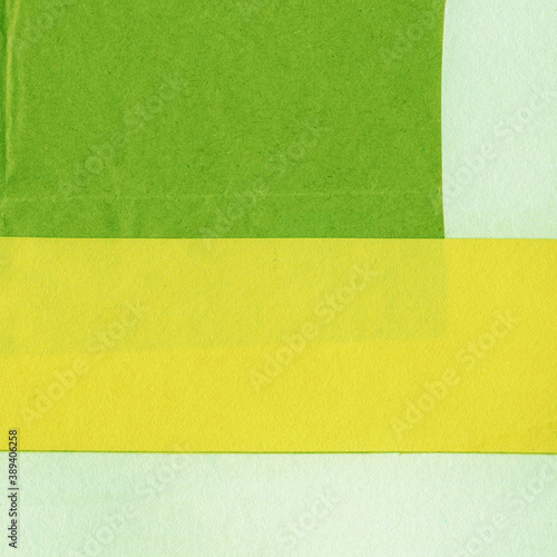 Green torn paper collage close-up. Texture made from various paper and cardboard parts. Damaged old paper background. Vintage blank wallpaper. Material design backdrop.