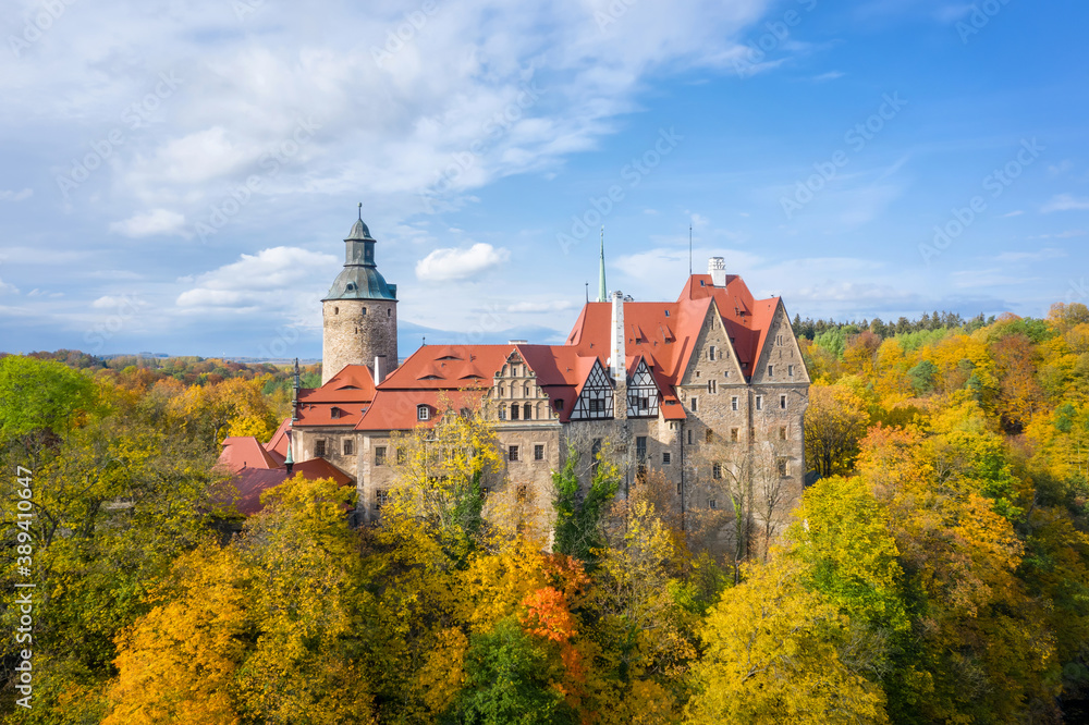 Aerial view of Czocha Castle surrounded by autumn yellow trees, Poland