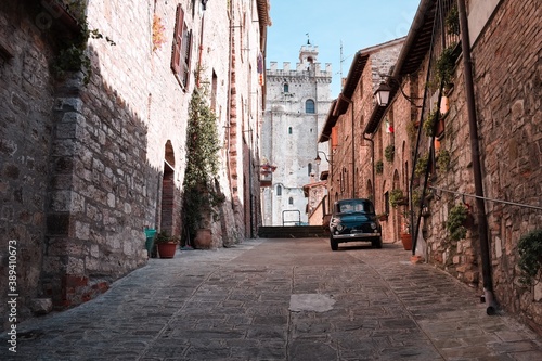 An alley of an Italian medieval village with an old car parked (Gubbio, Umbria, Italy)
