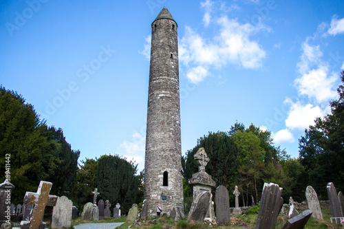 GLENDALOUGH, WICKLOW COUNTY, IRELAND - SEPTEMBER 12, 2018: The Round Tower at Glendalough's monastic city. Early Medieval monastic settlement founded in the 6th century by St Kevin. 