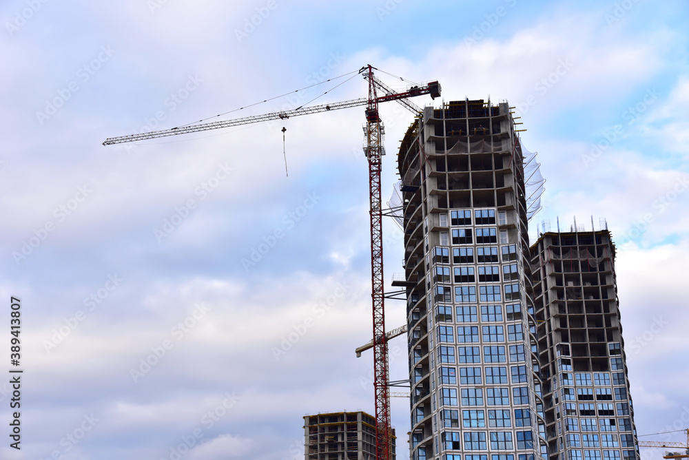 Tower cranes in action at construction site. Construction of skeleton of new modern residential buildings. Preparing to pour of concrete into formwork. Erection multi-storey residential building Tower cranes in action at construction site. Construction of skeleton of new modern residential buildings. Preparing to pour of concrete into formwork. Erection multi-storey residential building