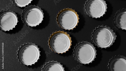 beer lids on a dark surface