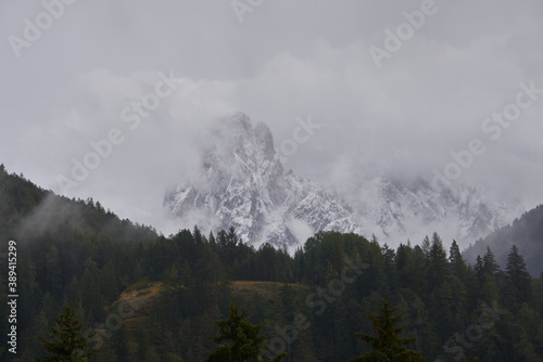 Mount with first snow in autumn is covered by clouds dolomites 2020