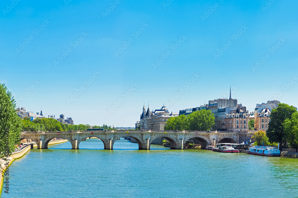 Summer cityscape of Paris, France. Quai du Louvre, Seine river, Pont Neuf, island of Cite. Castle conciergerie