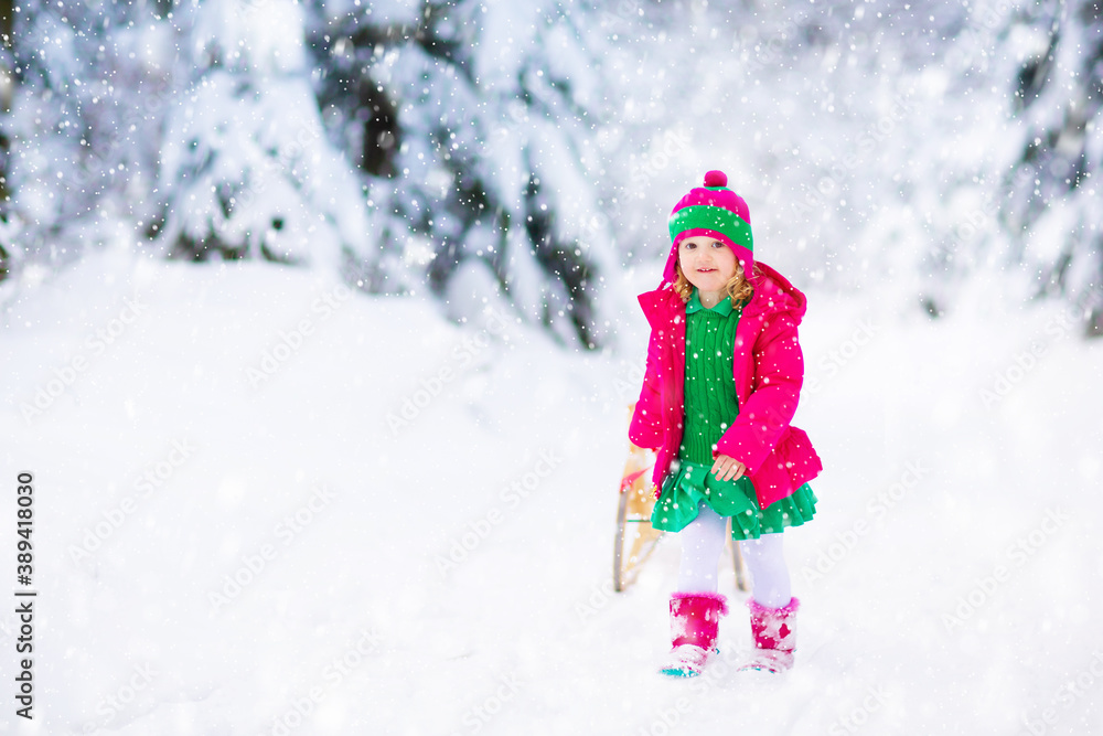 Girl on sled ride. Child sledding. Kid on sledge Girl on sled ride. Child sledding. Kid on sledge
