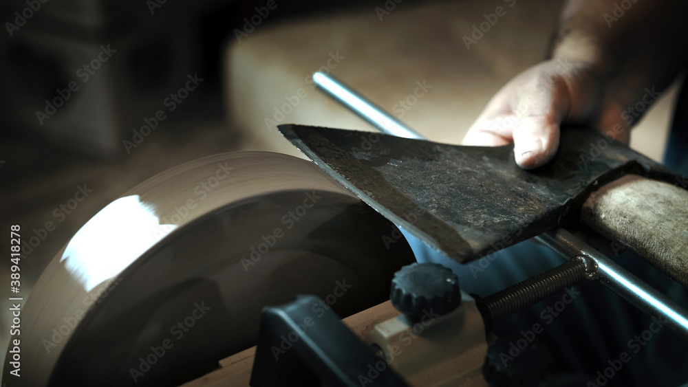Asian man sharpening axe on a grinder Stock Photo Adobe Stock