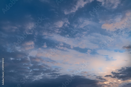 Summer evening sky in the picturesque clouds, lit by the rays of the setting sun.