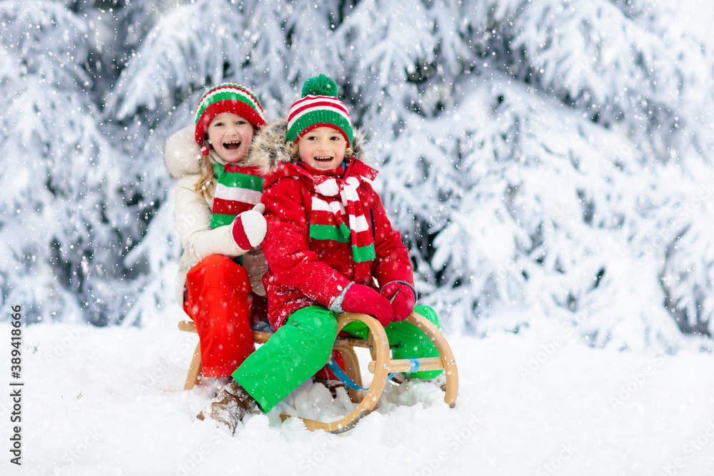 Kids play in snow. Winter sleigh ride for children