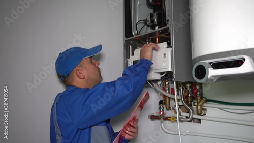 Technician inspector inspecting maintenance gas boiler heating system