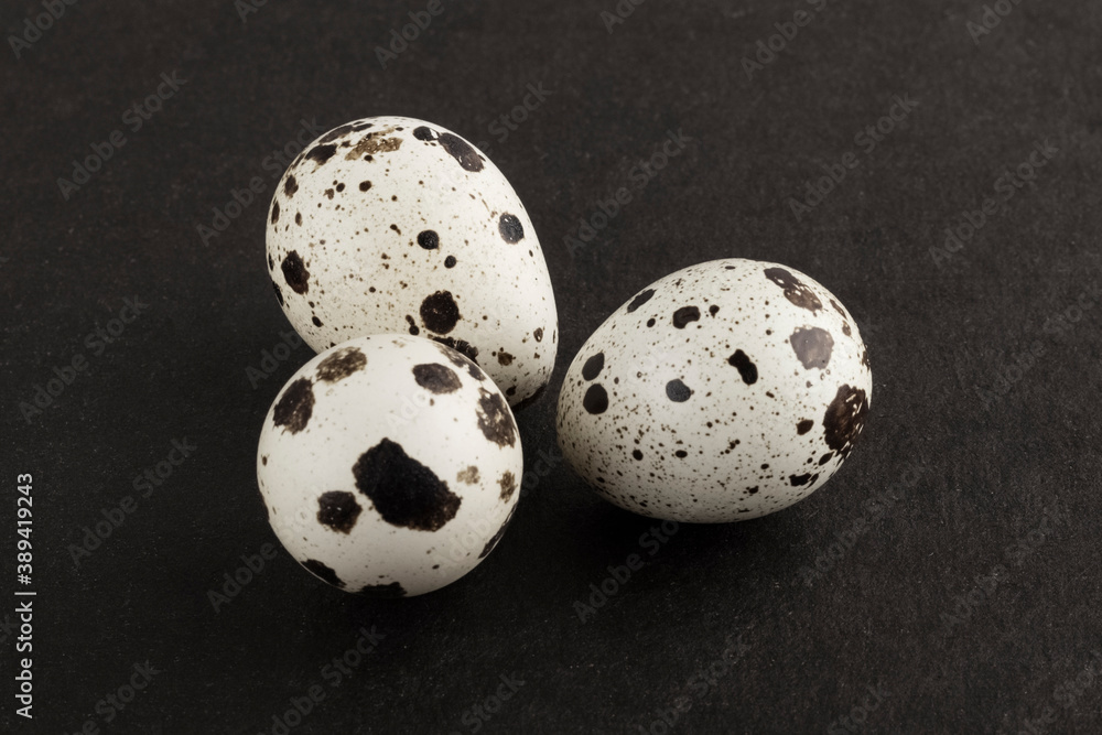 quail eggs. quail bird eggs on a dark textured background. top view