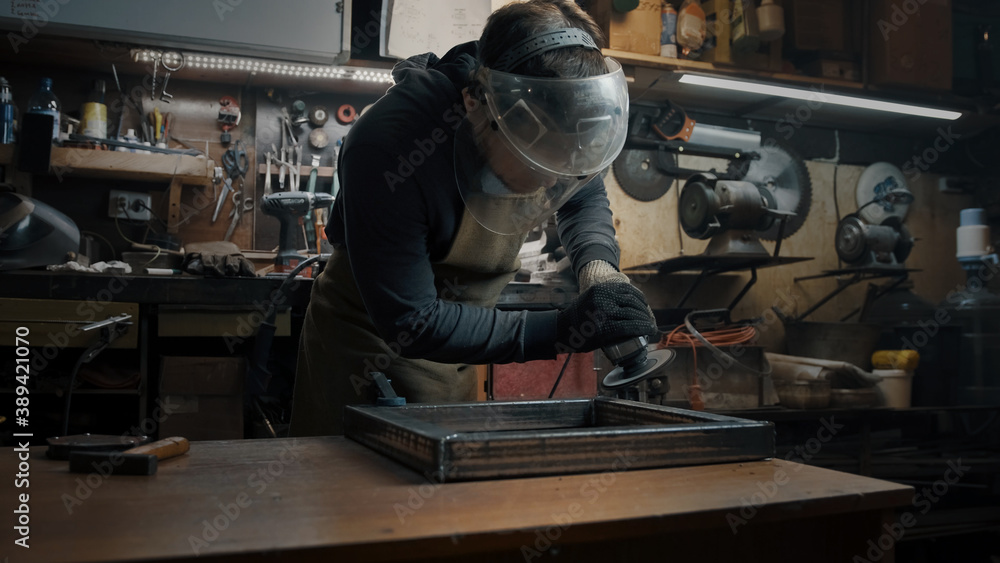 A man in gloves cuts metal with a circular saw, a lot of sparks. The working process A man in gloves cuts metal with a circular saw, a lot of sparks. The working process
