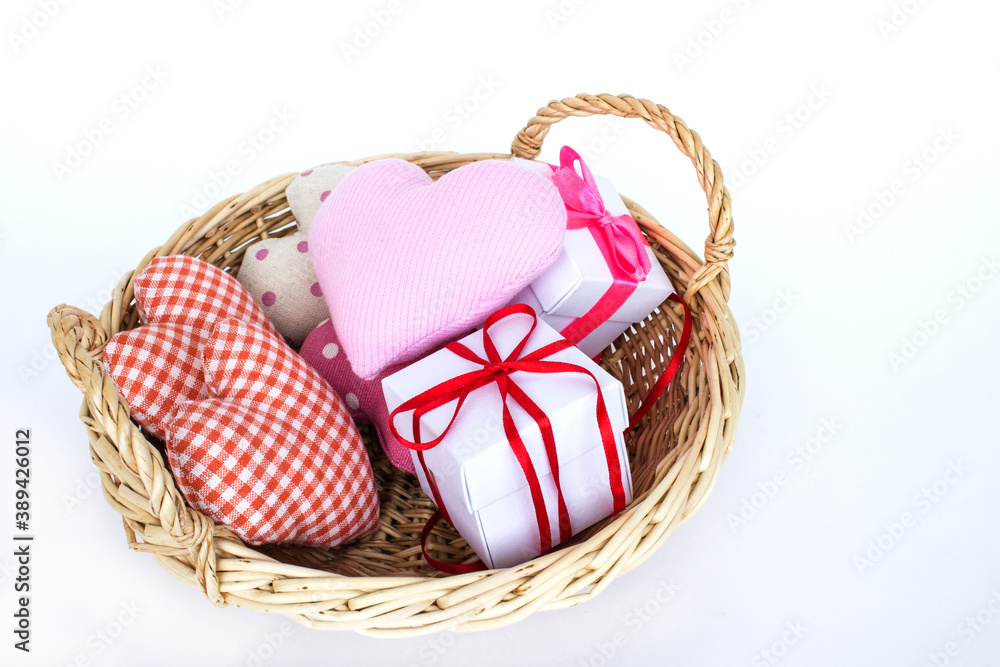 Gift basket and hearts isolated on a white background. The concept of gifts and congratulations for the holidays. Copy space.