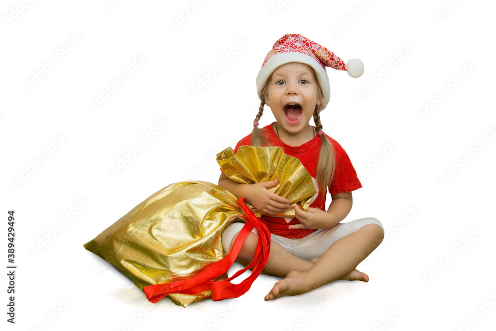 Beautiful happy girl in a Christmas santa hat with a bag of presents on a white background. The child rejoices and hugs a large Christmas bag with presents. Christmas and holiday concept. Isolate. Beautiful happy girl in a Christmas santa hat with a bag of presents on a white background. The child rejoices and hugs a large Christmas bag with presents. Christmas and holiday concept. Isolate.