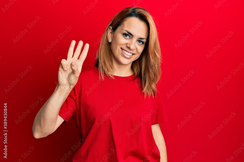 Hispanic young woman wearing casual red t shirt showing and pointing up with fingers number three while smiling confident and happy. Hispanic young woman wearing casual red t shirt showing and pointing up with fingers number three while smiling confident and happy.