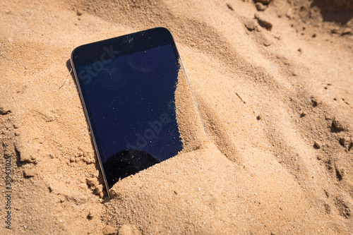mobile phone lost and lying in the sand