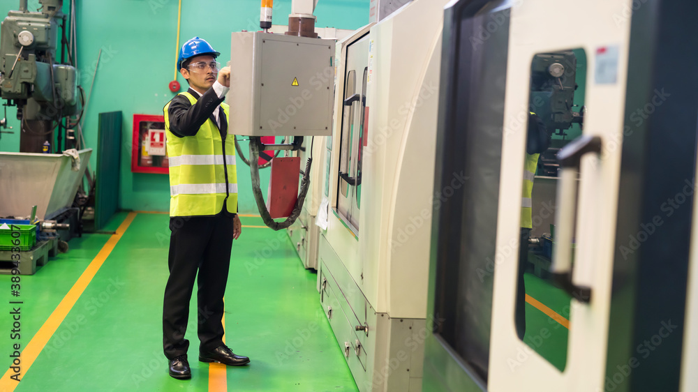 Factory manager operating CNC machine center Factory manager operating CNC machine center