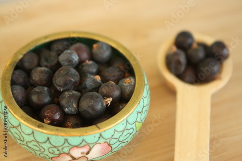Wooden spoon with juniper berries.