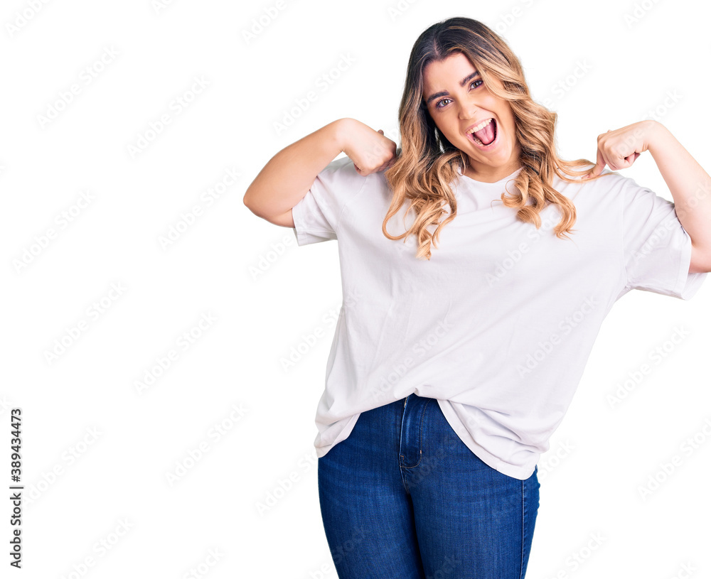 Fototapeta premium Young caucasian woman wearing casual clothes looking confident with smile on face, pointing oneself with fingers proud and happy.