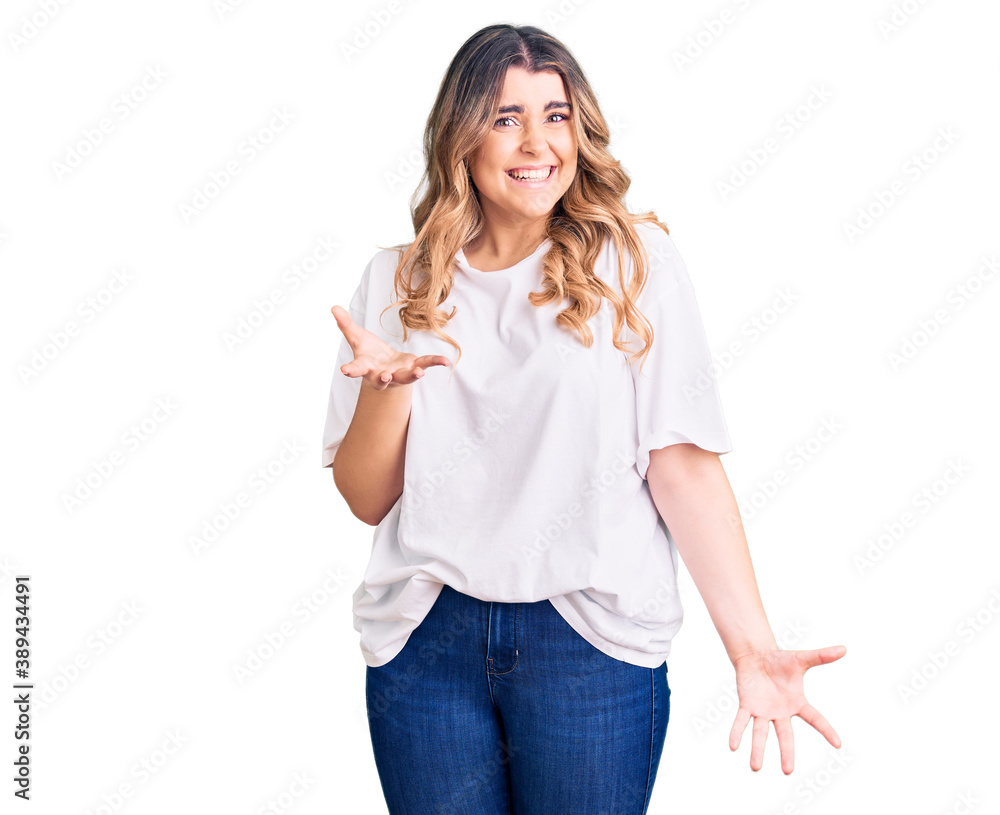 Young caucasian woman wearing casual clothes smiling cheerful with open arms as friendly welcome, positive and confident greetings Young caucasian woman wearing casual clothes smiling cheerful with open arms as friendly welcome, positive and confident greetings