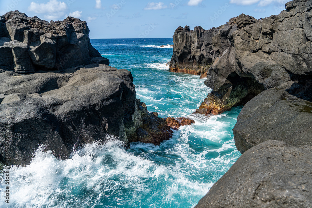 Azores, on Sao Miguel Island at the Ponta da Ferraria. The waves are playing with the lava rocks. Beautiful scenery