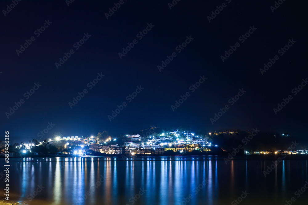 Fourka Scala city with lights reflection at night in Halkidiki,